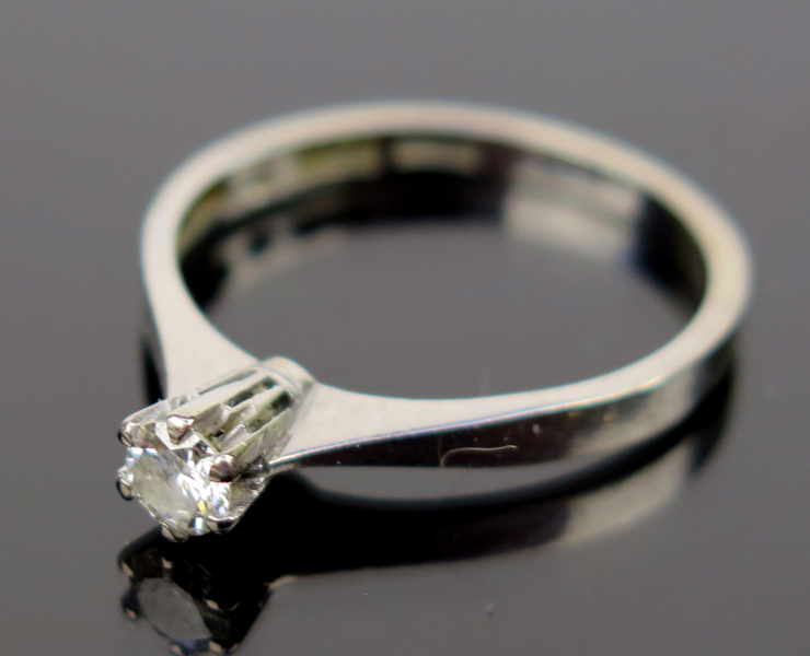 Ring, 18 karat vitguld med briljantslipad diamant om 0,17 carat enligt gravyr, vikt 2,5 gram_18666b_8da23ba86b51157_lg.jpeg